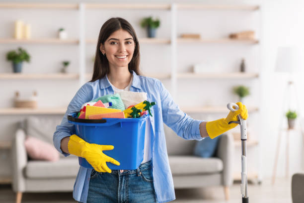 Professional cleaner wiping office desk